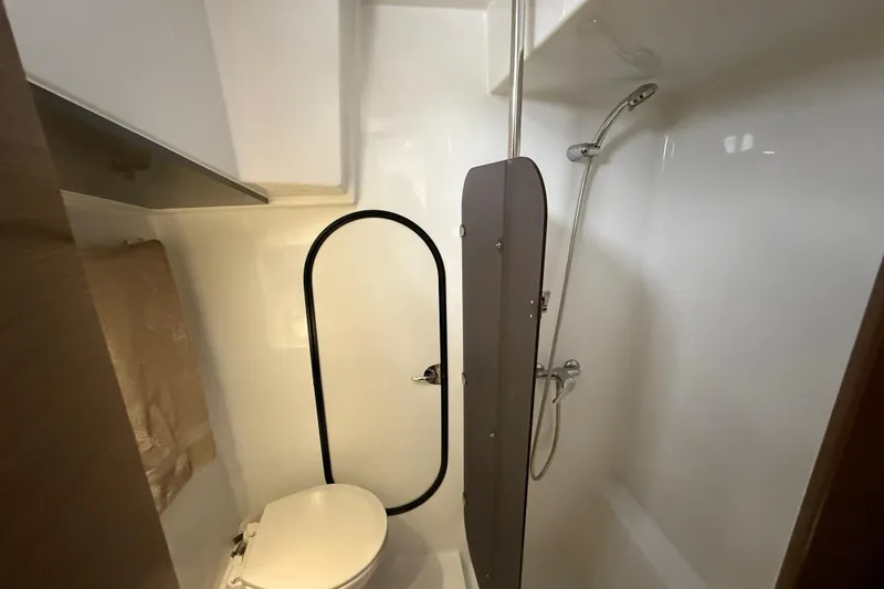 Ohana Yacht Photos Pics Bathroom interior of 2015 Fountaine Pajot Summerland 40 LC yacht, featuring shower and toilet.