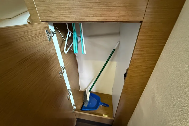Ohana Yacht Photos Pics Storage cabinet with cleaning tools on a 2015 Fountaine Pajot Summerland 40 LC.