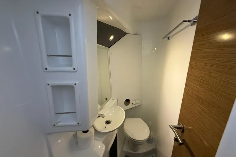 Ohana Yacht Photos Pics Compact bathroom in 2015 Fountaine Pajot Summerland 40 LC yacht, featuring sink and toilet.