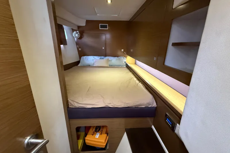Ohana Yacht Photos Pics Cozy cabin interior of 2015 Fountaine Pajot Summerland 40 LC with wooden accents and bed.