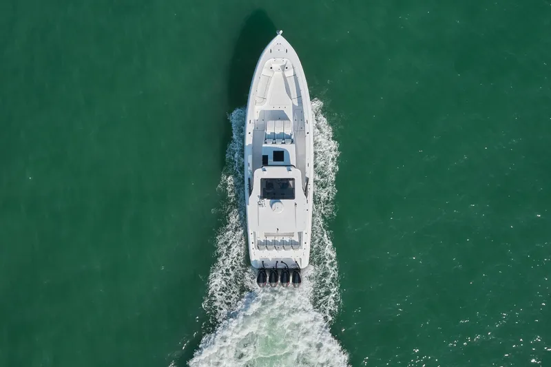  Yacht Photos Pics Aerial view of 2021 Midnight Express 43' Open boat cruising on green water.