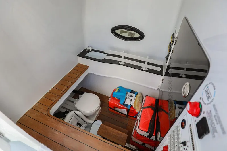  Yacht Photos Pics 2023 Contender 44 ST boat interior with toilet, storage, and control panel.