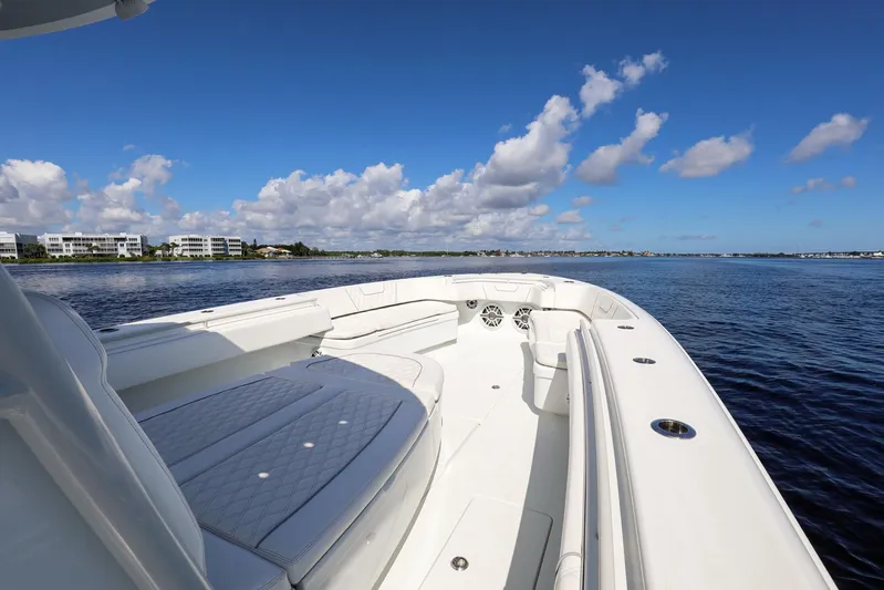  Yacht Photos Pics 2023 Contender 44 ST boat on calm water under a clear blue sky.