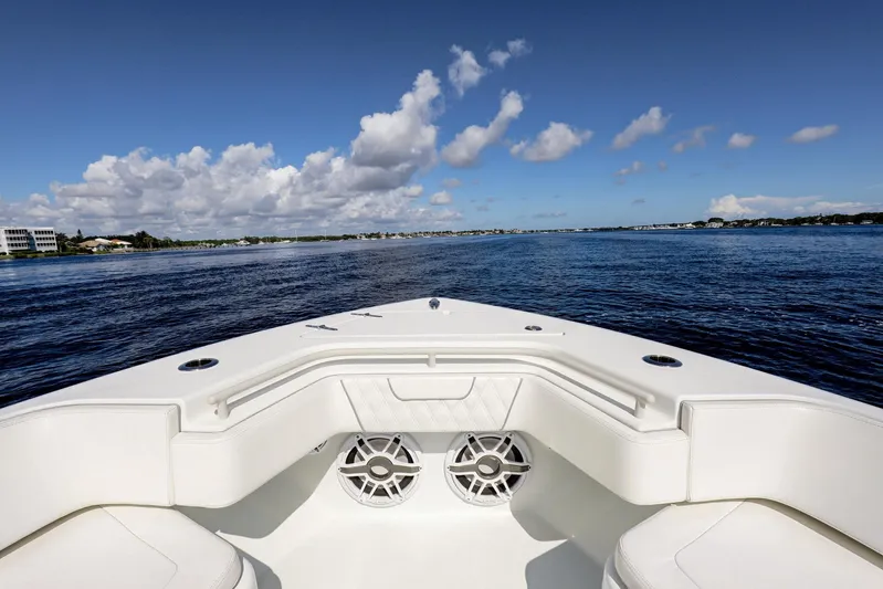 Yacht Photos Pics 2023 Contender 44 ST boat on open water under a clear blue sky.