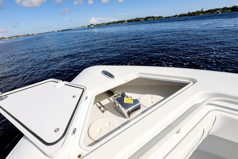  Yacht Photos Pics 2023 Contender 44 ST boat with open anchor hatch on calm water.