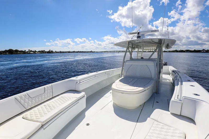  Yacht Photos Pics 2023 Contender 44 ST boat on open water under a clear blue sky.