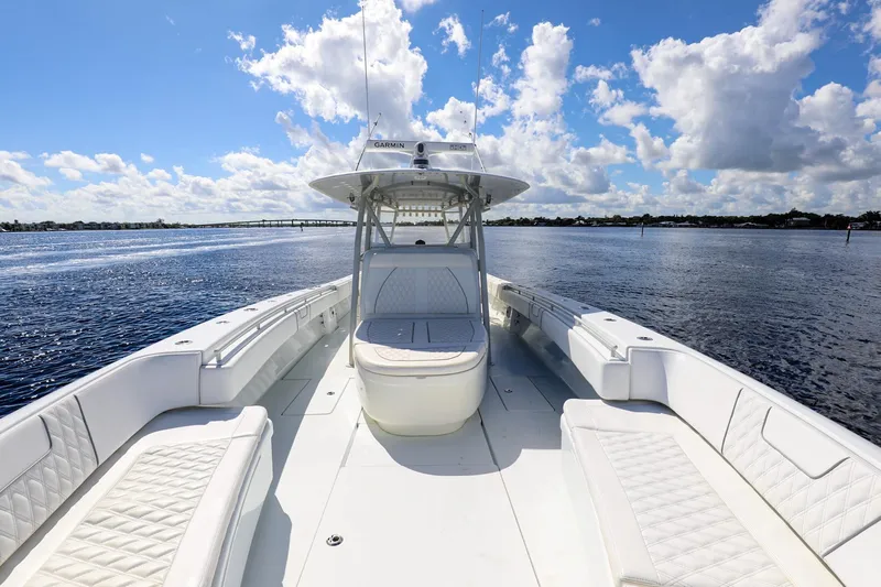  Yacht Photos Pics 2023 Contender 44 ST boat on open water under a blue sky with clouds.