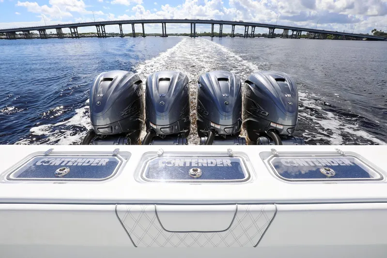  Yacht Photos Pics 2023 Contender 44 ST boat with four powerful outboard engines on open water.