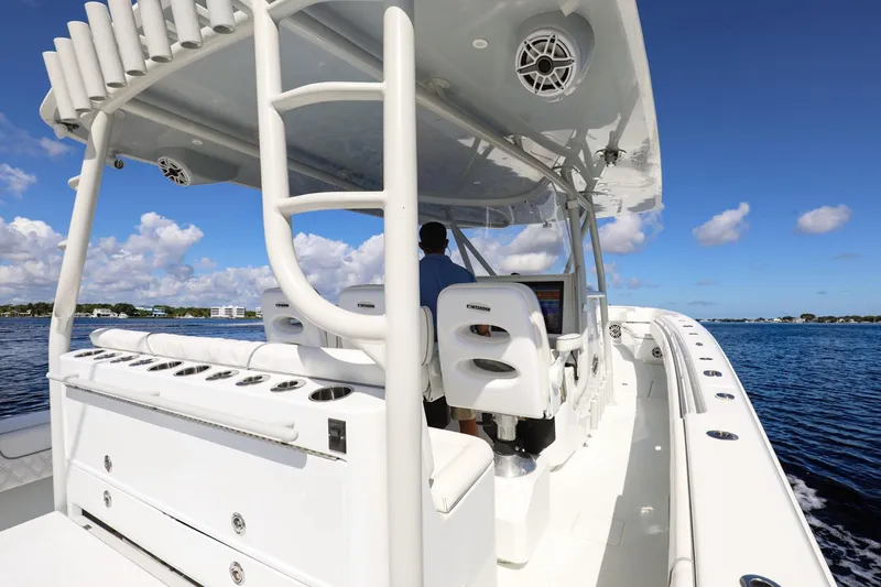  Yacht Photos Pics 2023 Contender 44 ST boat on water, featuring sleek design and modern controls.