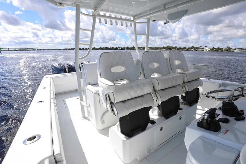  Yacht Photos Pics 2023 Contender 44 ST boat interior with luxurious seating and ocean view.