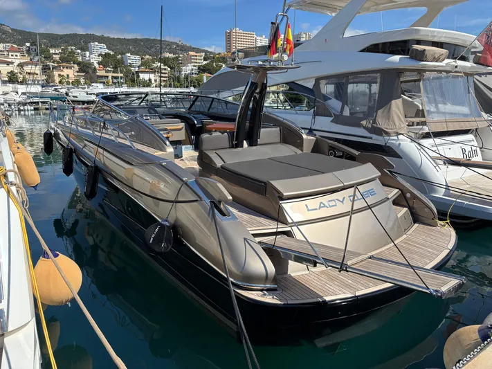 (2021 And 2024 Retrofit) Yacht Photos Pics 2003 Riva 52' LE luxury yacht docked in a marina, showcasing sleek design and elegance.