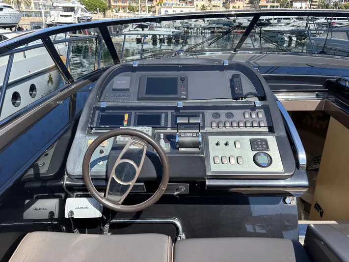 (2021 And 2024 Retrofit) Yacht Photos Pics Cockpit of a 2003 Riva 52' LE yacht with modern navigation controls.