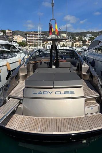 (2021 And 2024 Retrofit) Yacht Photos Pics 2003 Riva 52' LE yacht docked in marina, rear view with "Lady Cube" nameplate.