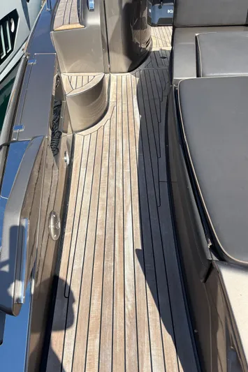 (2021 And 2024 Retrofit) Yacht Photos Pics 2003 Riva 52' le yacht deck with sleek wooden finish and modern design.