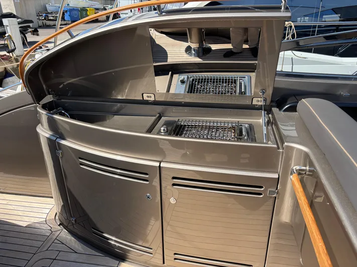 (2021 And 2024 Retrofit) Yacht Photos Pics Outdoor kitchen area on a 2003 Riva 52' LE yacht with grill and storage.