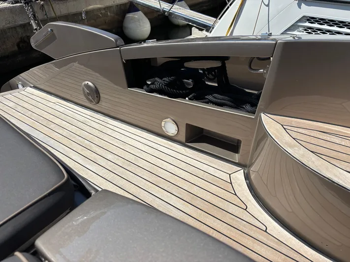 (2021 And 2024 Retrofit) Yacht Photos Pics 2003 Riva 52' le yacht deck with sleek wood finish and modern design elements.