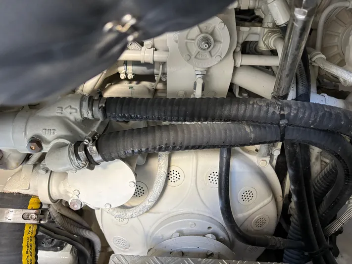 (2021 And 2024 Retrofit) Yacht Photos Pics Engine components of a 2003 Riva 52' le yacht, featuring hoses and mechanical parts.