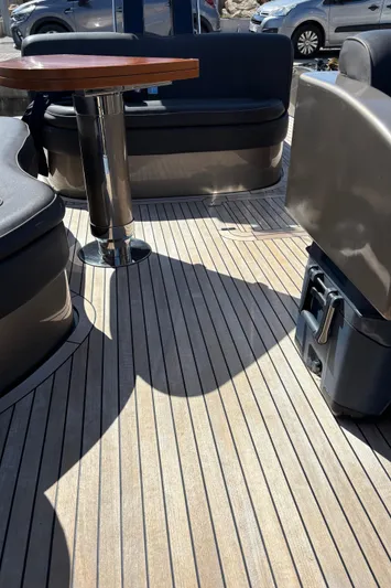 (2021 And 2024 Retrofit) Yacht Photos Pics 2003 Riva 52' le yacht deck with seating and table, showcasing luxury marine design.