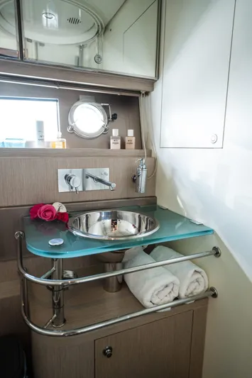 (2021 And 2024 Retrofit) Yacht Photos Pics Luxurious bathroom on 2003 Riva 52' LE yacht with modern sink and elegant decor.