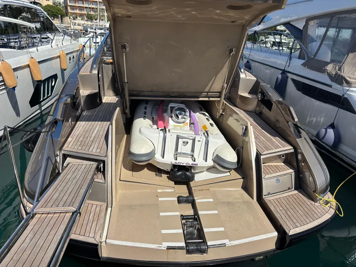 (2021 And 2024 Retrofit) Yacht Photos Pics 2003 Riva 52' le yacht with open storage compartment and inflatable boat.
