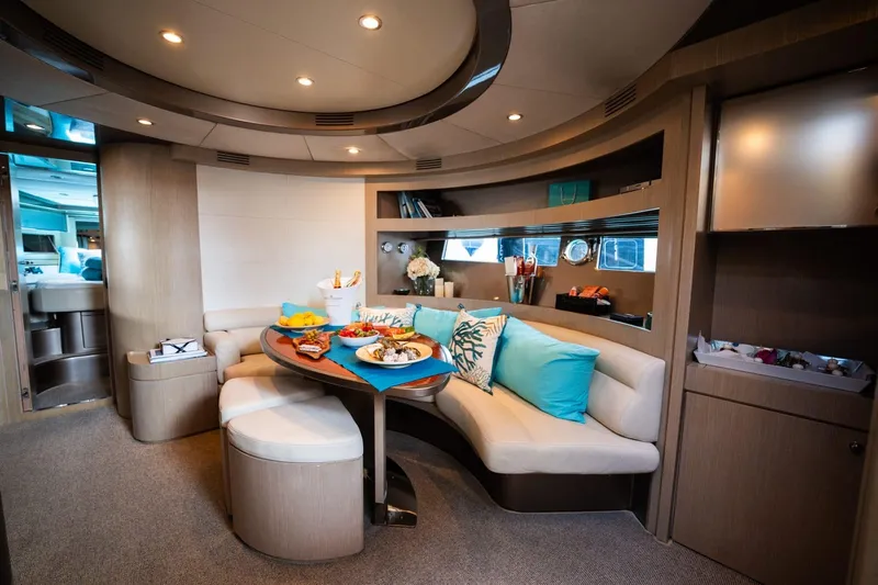 (2021 And 2024 Retrofit) Yacht Photos Pics Luxurious interior of a 2003 Riva 52' le yacht with elegant seating and dining area.