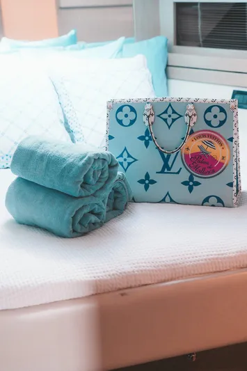 (2021 And 2024 Retrofit) Yacht Photos Pics Luxury yacht interior with designer bag and folded towels on bed, Riva 52' le, 2003.