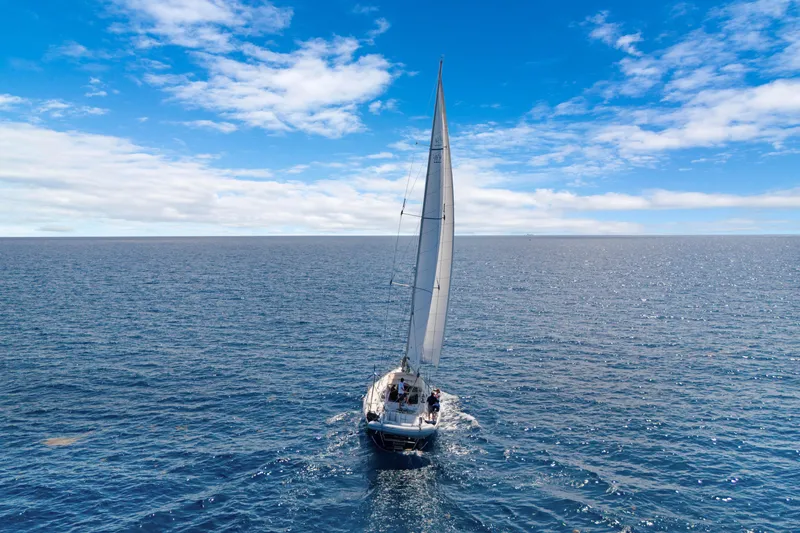 Mrs Jones Yacht Photos Pics Sailing yacht Hylas 54 (2009) navigating open ocean under clear blue sky.