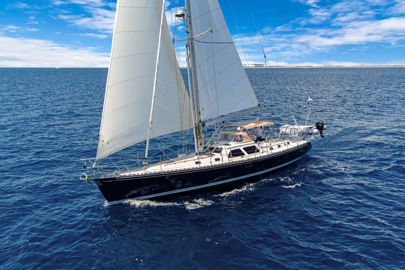 Mrs Jones Yacht Photos Pics Sailing yacht Hylas 54 (2009) gliding on open ocean under clear blue skies.