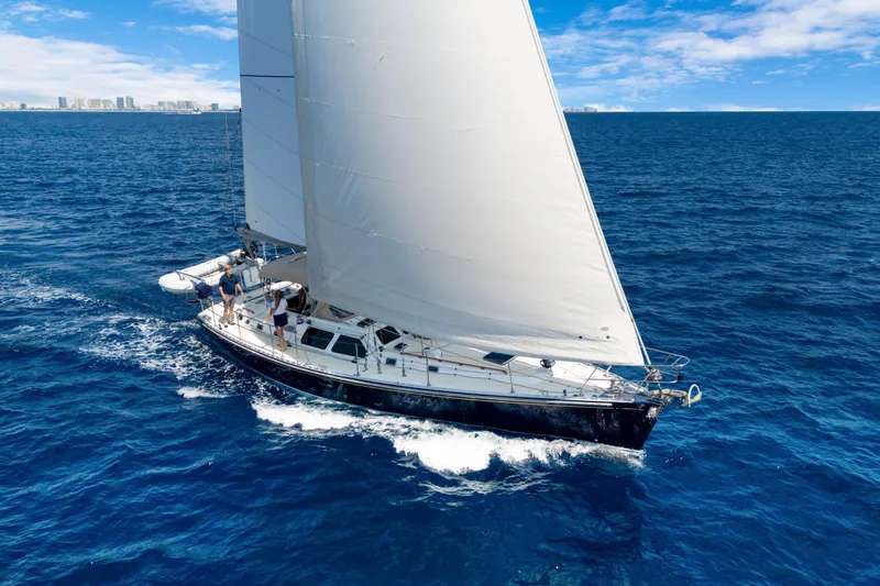 Mrs Jones Yacht Photos Pics Sailing yacht Hylas 54, 2009 model, cruising on open blue ocean under clear skies.