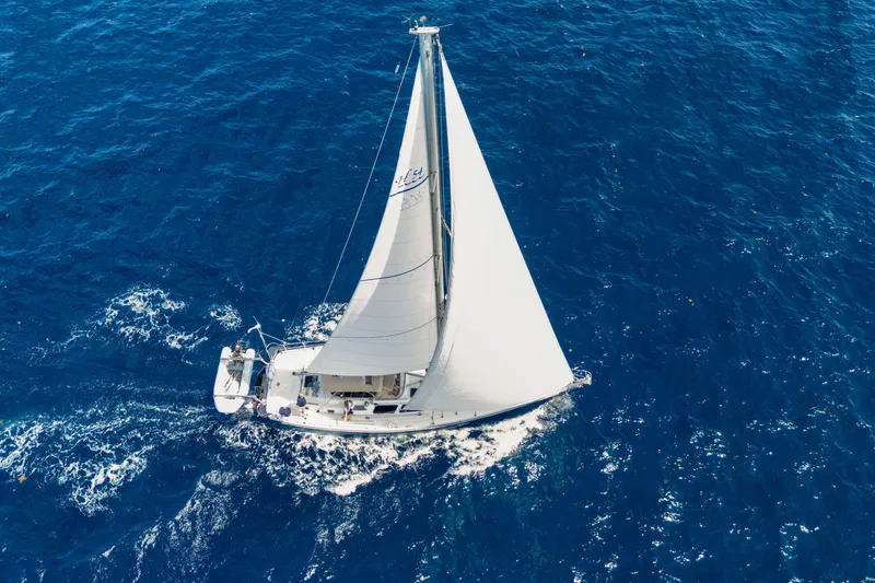 Mrs Jones Yacht Photos Pics Sailing yacht Hylas 54, 2009 model, cruising on open blue sea.