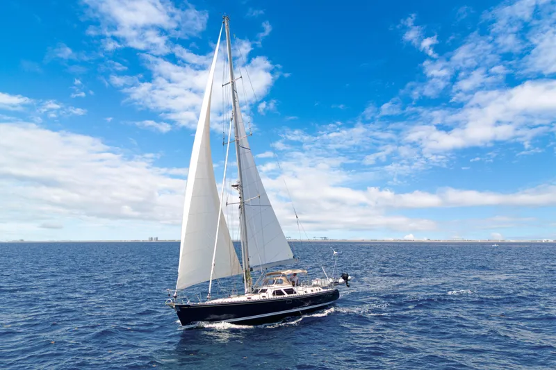 Mrs Jones Yacht Photos Pics Sailing yacht Hylas 54 (2009) cruising on open sea under clear blue sky.