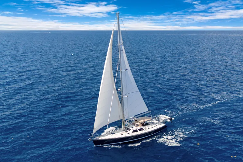 Mrs Jones Yacht Photos Pics Sailing yacht Hylas 54 (2009) cruising on open ocean under clear blue skies.