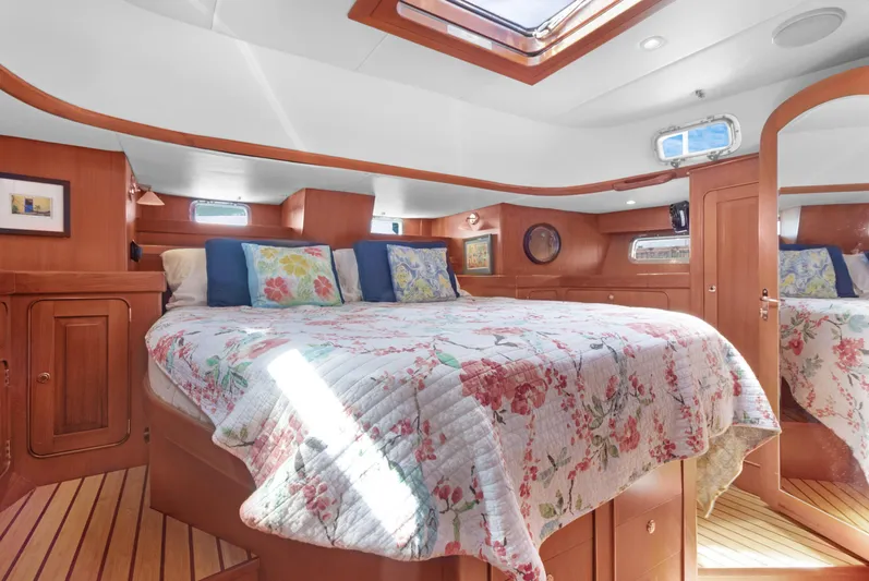 Mrs Jones Yacht Photos Pics Luxurious cabin interior of 2009 Hylas 54 yacht with floral bedding and wood finish.