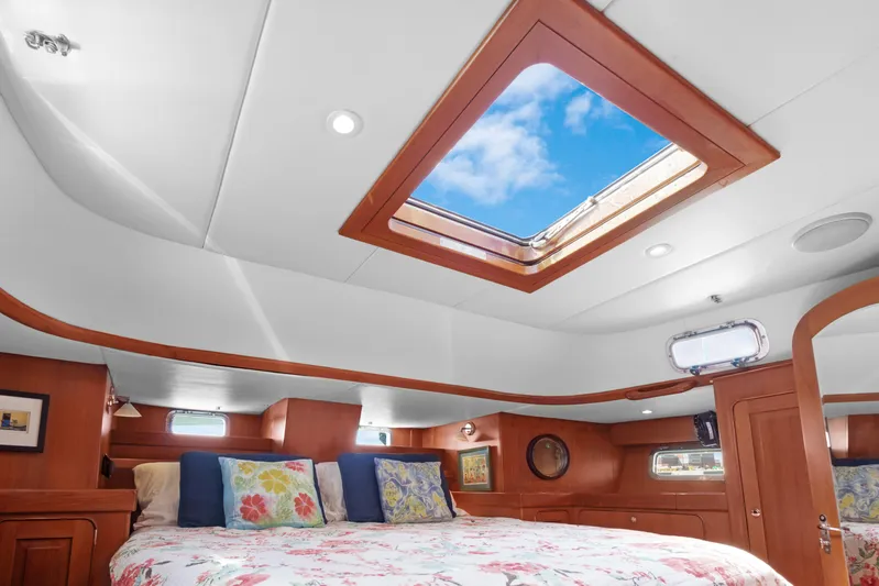 Mrs Jones Yacht Photos Pics Luxurious cabin interior of 2009 Hylas 54 yacht with skylight and cozy bedding.