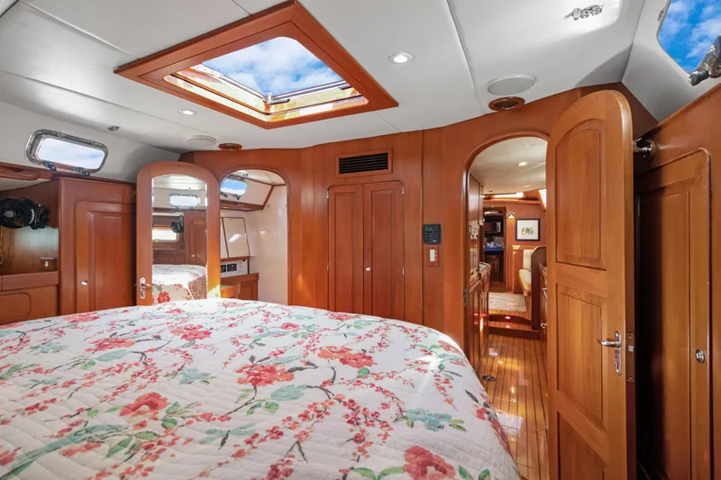 Mrs Jones Yacht Photos Pics Luxurious 2009 Hylas 54 yacht interior with floral bedding and wooden cabinetry.