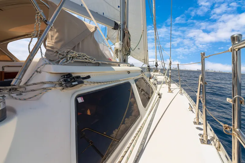 Mrs Jones Yacht Photos Pics Sailing yacht Hylas 54, 2009 model, cruising on open water under a clear blue sky.
