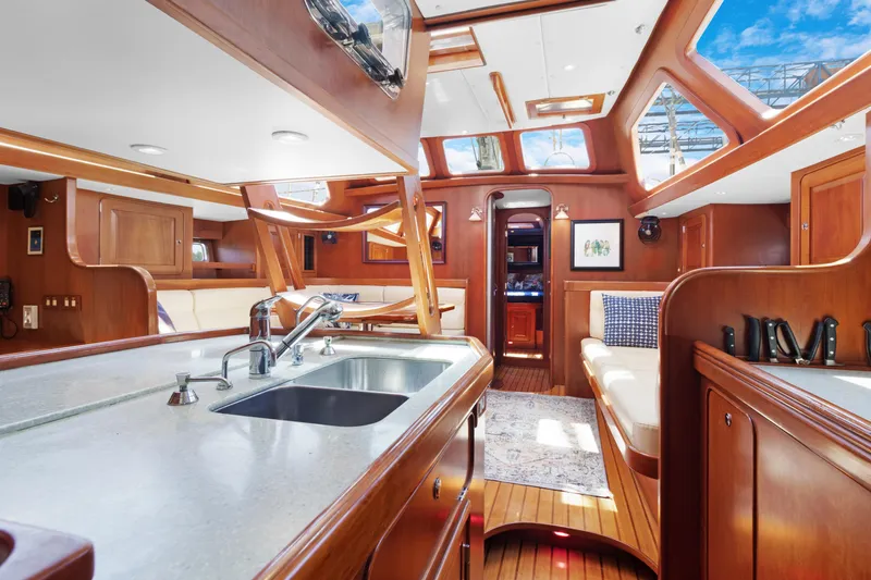 Mrs Jones Yacht Photos Pics Luxurious interior of 2009 Hylas 54 yacht with wooden finishes and skylights.
