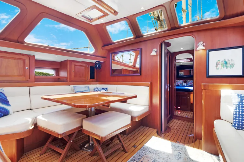 Mrs Jones Yacht Photos Pics Luxurious interior of 2009 Hylas 54 yacht with elegant wood finish and plush seating.
