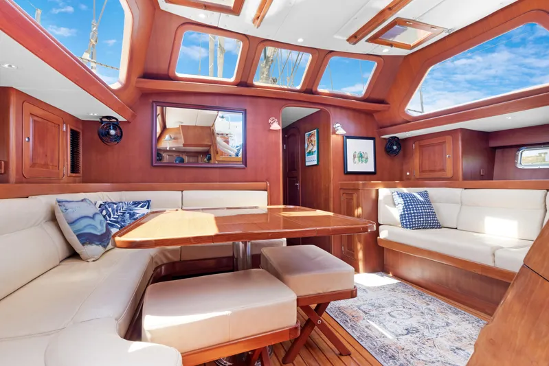 Mrs Jones Yacht Photos Pics Luxurious interior of a 2009 Hylas 54 yacht with elegant wood finishes and plush seating.