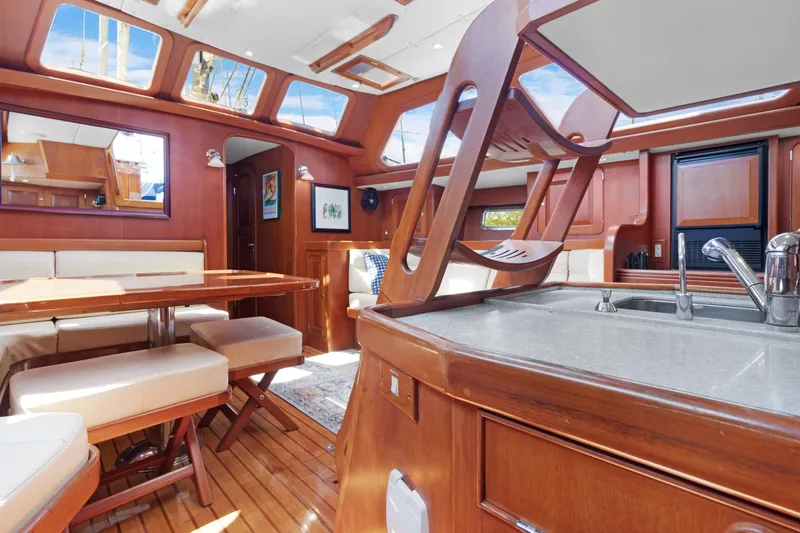 Mrs Jones Yacht Photos Pics Luxurious interior of 2009 Hylas 54 yacht with wooden finishes and modern amenities.