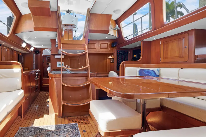 Mrs Jones Yacht Photos Pics Luxurious interior of 2009 Hylas 54 yacht with wooden finishes and comfortable seating.