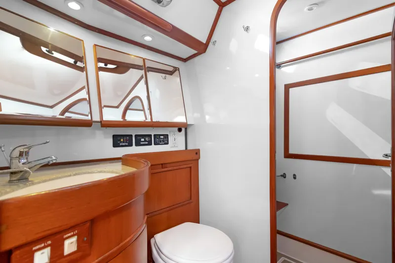 Mrs Jones Yacht Photos Pics Luxurious bathroom in a 2009 Hylas 54 yacht, featuring wood accents and modern fixtures.