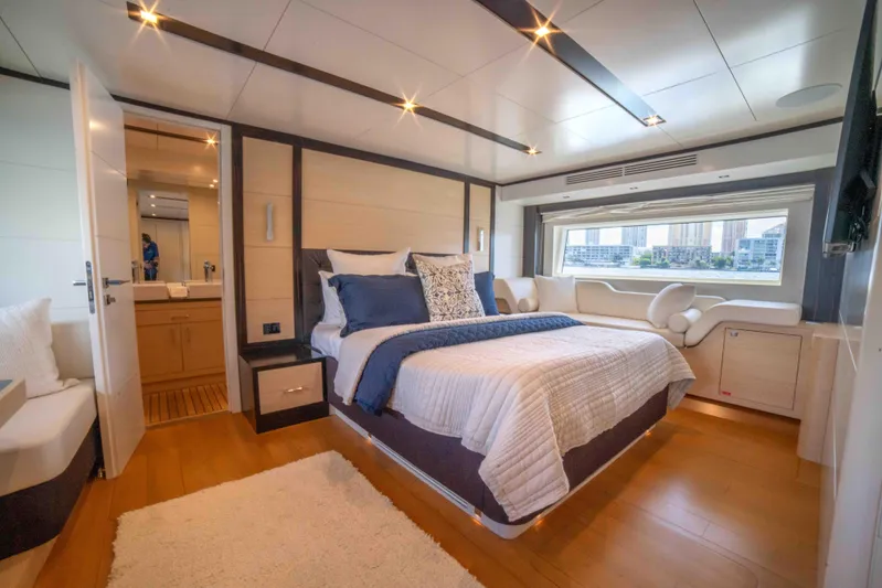Sand Bar Yacht Photos Pics Luxurious bedroom interior of 2018 Sirena 64 yacht with modern decor and large window.