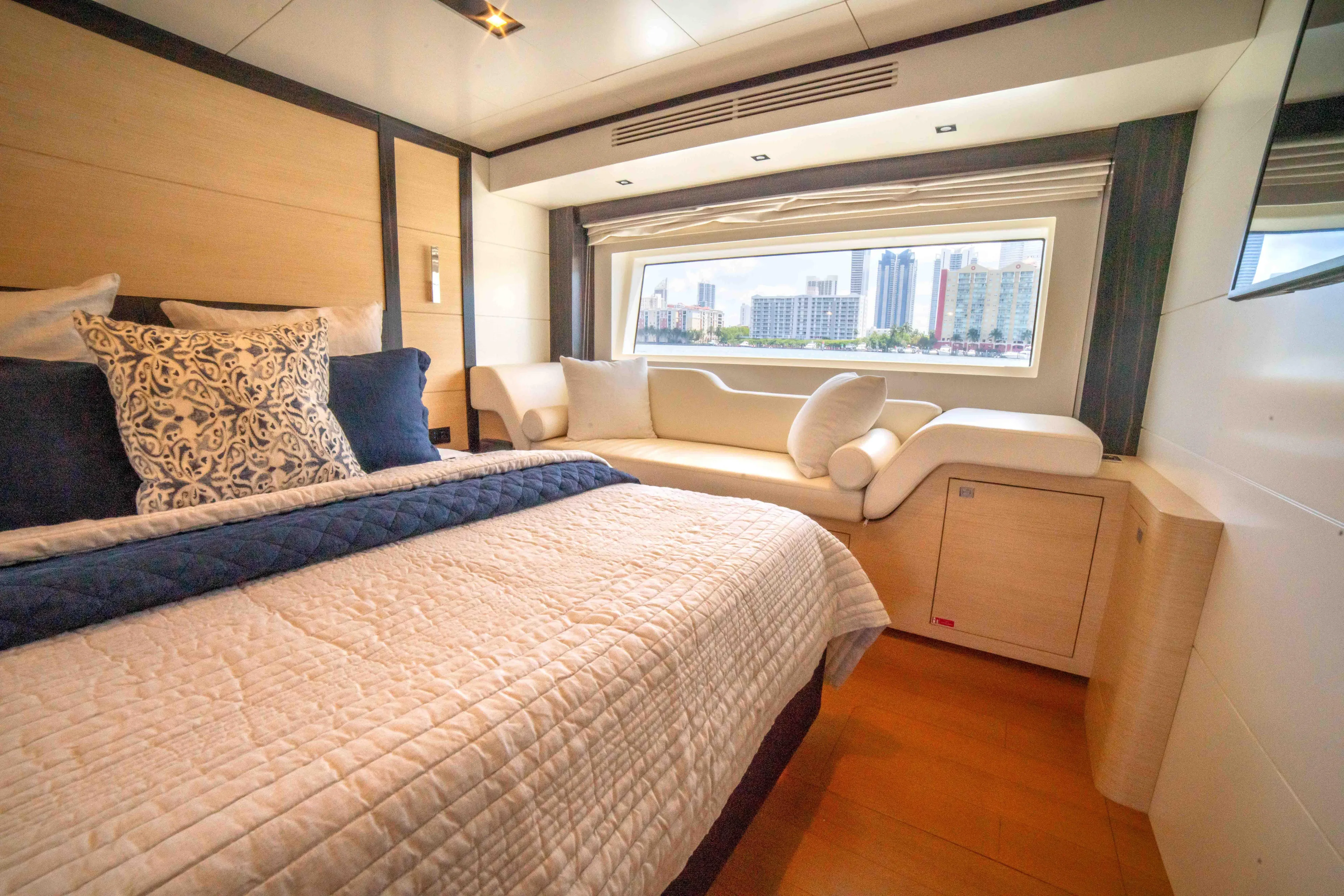 Sand Bar Yacht Photos Pics Luxurious bedroom interior of 2018 Sirena 64 yacht with cityscape view.