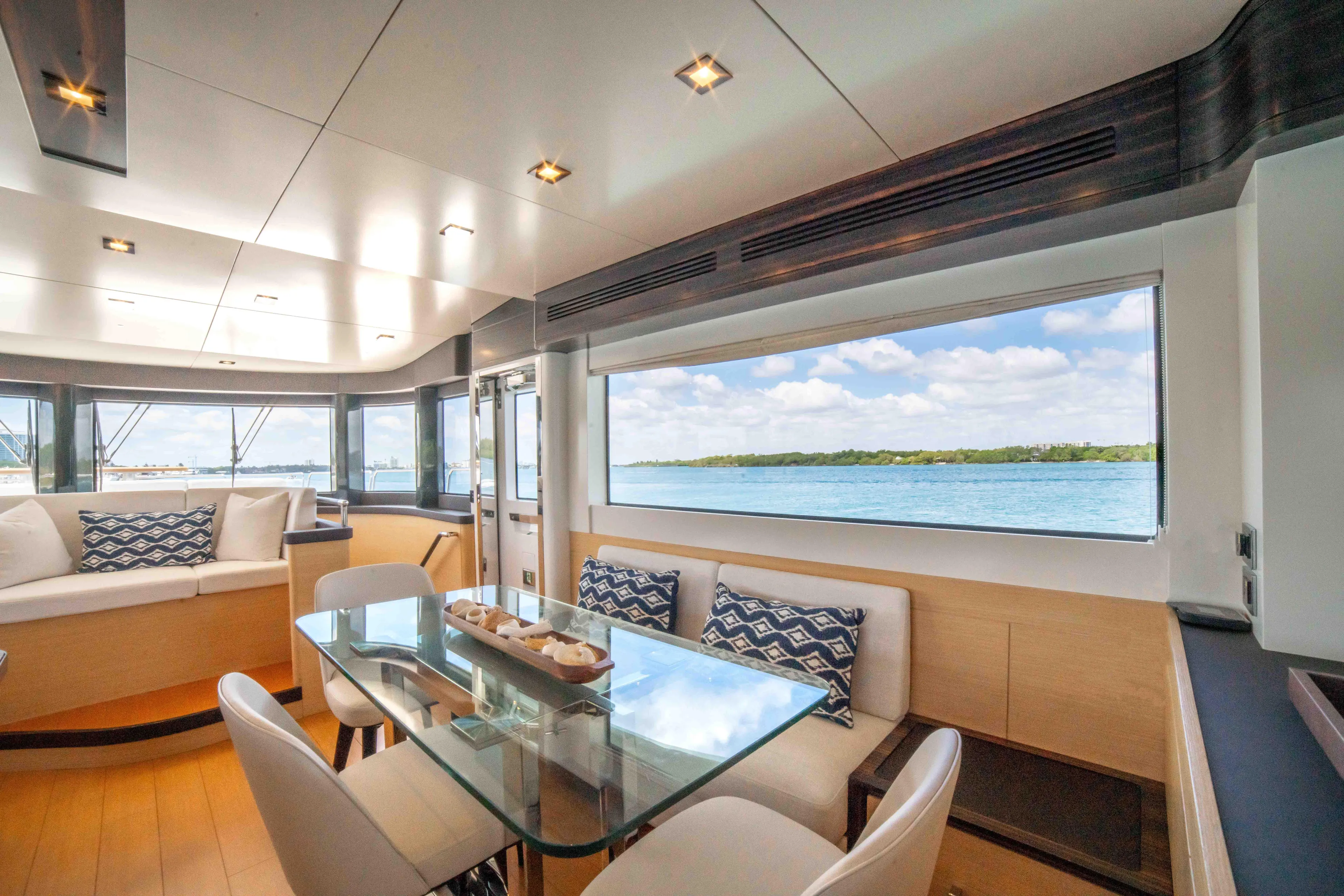 Sand Bar Yacht Photos Pics Luxurious interior of 2018 Sirena 64 yacht with panoramic windows and modern furnishings.