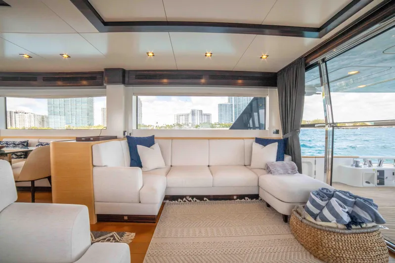 Sand Bar Yacht Photos Pics Luxurious interior of 2018 Sirena 64 yacht with white sofas and ocean view.