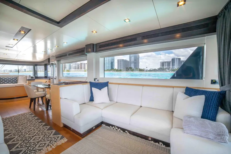 Sand Bar Yacht Photos Pics Luxurious interior of 2018 Sirena 64 yacht with white sofa and large windows.