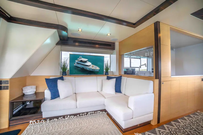 Sand Bar Yacht Photos Pics Luxurious interior of 2018 Sirena 64 yacht with white sofa and ocean view.