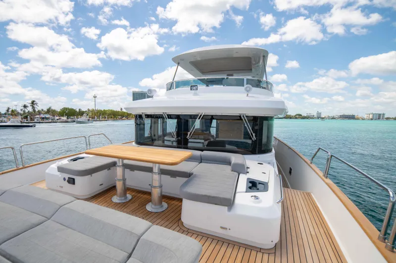 Sand Bar Yacht Photos Pics 2018 Sirena 64 yacht with spacious deck and seating area on a sunny day.