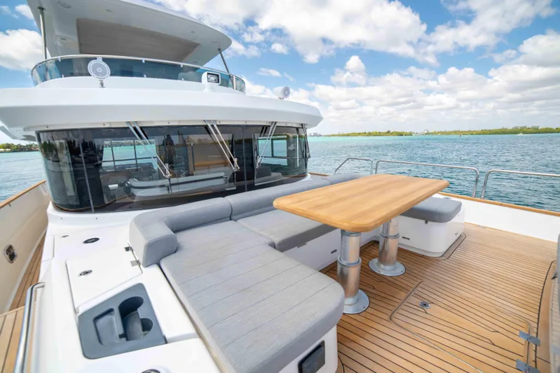 Sand Bar Yacht Photos Pics 2018 Sirena 64 yacht with outdoor seating and dining area on deck.